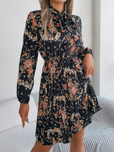 Load image into Gallery viewer, Pleated Printed Tie Neck Long Sleeve Dress